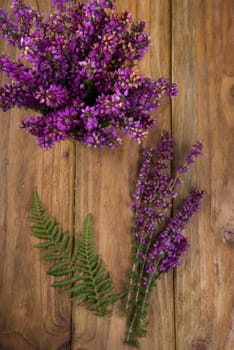 purple and viola heather flowers on wooden table