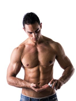 Macho male model putting shaving cream in his hand on white background