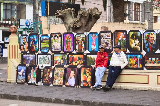 BANOS, ECUADOR - FEBRUARY 22, 2014: Unidentified people selling paintings outside the park Palomino Flores on Ambato Street on February 22, 2014 in Banos, Ecuador. Banos is a small touristy town, which is popular with both Ecuadorian and foreign tourists.