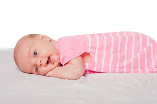 Cute happy baby infant girl laying on belly tummy, on white.