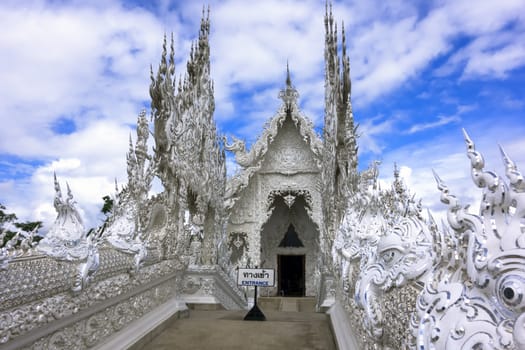 White Temple Entrance. Contemporary unconventional Buddhist temple in Chiang Rai, Thailand.