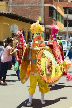 BANOS, ECUADOR - MARCH 2, 2014: Unidentified person dressed in traditional costume and dancing to music on the carnival parade on Maldonado street on March 2, 2014 in Banos, Ecuador.