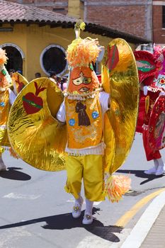 BANOS, ECUADOR - MARCH 2, 2014: Unidentified person dressed in traditional costume and dancing to music on the carnival parade on Maldonado street on March 2, 2014 in Banos, Ecuador.