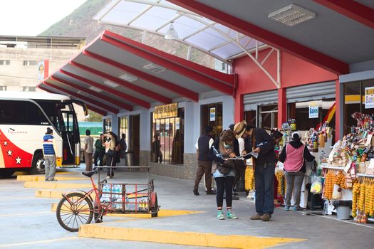 BANOS, ECUADOR - MARCH 7, 2014: Unidentified people looking at a map in the bus terminal on March 7, 2014 in Banos, Ecuador. 