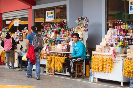 BANOS, ECUADOR - MARCH 7, 2014: Unidentified young man at a snack stand in the bus terminal on March 7, 2014 in Banos, Ecuador