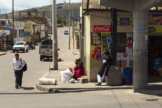 TUNGURAHUA PROVINCE, ECUADOR - JULY 29, 2014: Unidentified people on the street in a settlement along the road between Ambato and Banos on July 29, 2014 in Ecuador. 