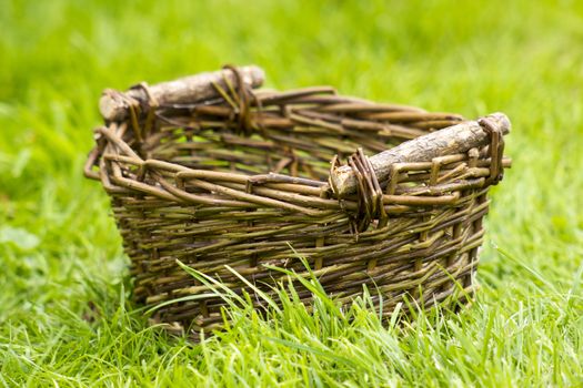 An empty wicker basket on the grass