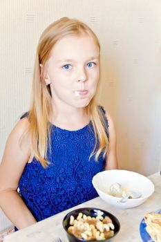 Photo of eating cute girl with blond hair