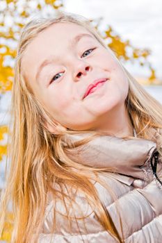Photo of cute smiling girl in autumn