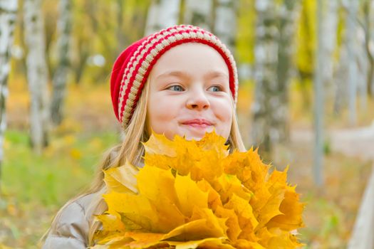 Photo of cute smiling girl in autumn