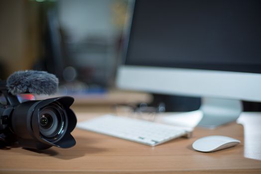 Video editing workstation with video camera beside monitor