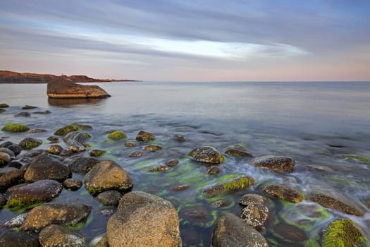 Sunset over the rolling stones of the Norwegian coast, Moelen