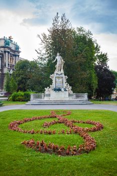 VIENNA, AUSTRIA - AUGUST 4, 2013: Statue of Amadeus Mozart with treble clef in Burggarten, Vienna, Austria