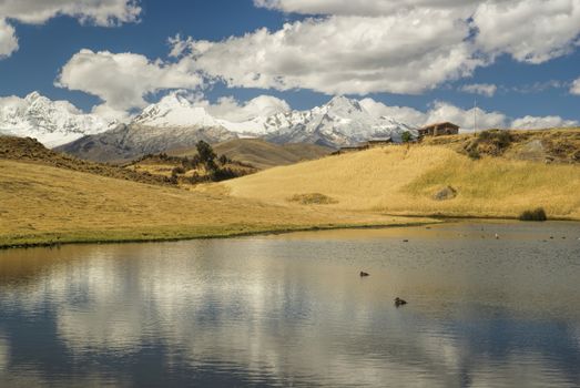 Picturesque view of clouds reflected on the surface of a lake in Cordillera Negra, Peru