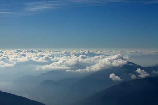 Misty mountain landscape above the clouds