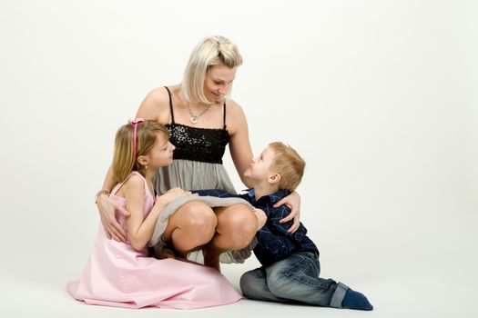 Studio portrait of siblings beautiful boy and girl and mother