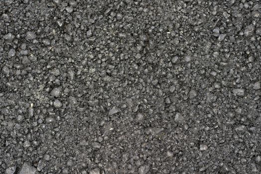 New black rough asphalt. The construction background