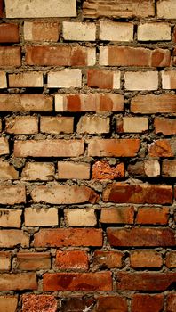 Background of Old Damaged Red Variegated Brick with Concrete Smoothing. Vertical View