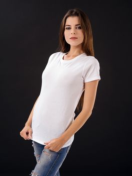 Photo of a young beautiful sexy female with blank white shirt, front and back, over black background. Ready for your design or artwork.