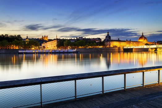 night view from Rhone river in Lyon city with Hotel Dieu and Fourviere cathedral, France