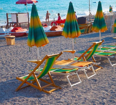 Empty deckchiars on the beach, facing the sea