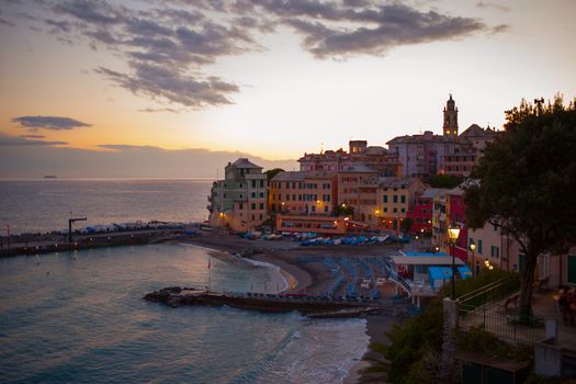 Wonderful sunset over sea town, with a far ship (focus over the buildings)