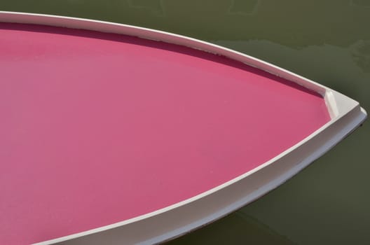 Part of boat painted in a vivid Fuchsia color in the island of Burano, Venice, Italy
