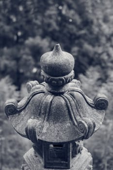 Traditional asian stone lantern in garden.