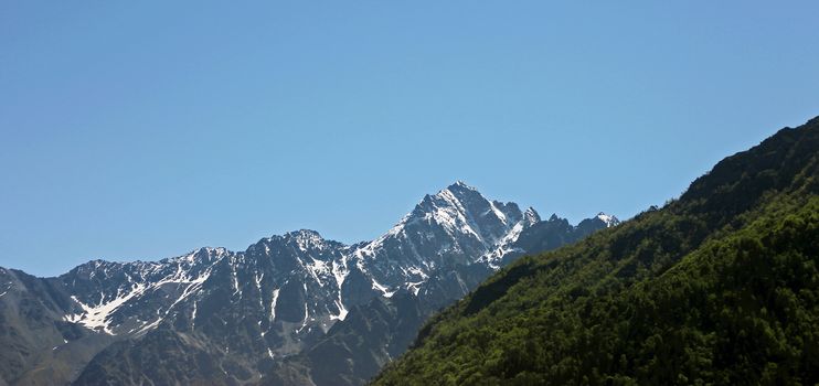 Caucasus mountains under snow and clear blue sky