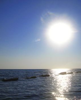 Sunset over summer sea with a small waves