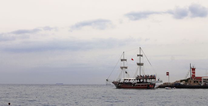 Sail ship moving away from the shore