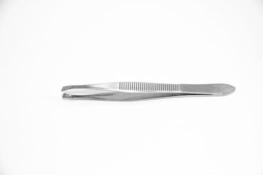 Little metal hair tweezers isolated over white background.