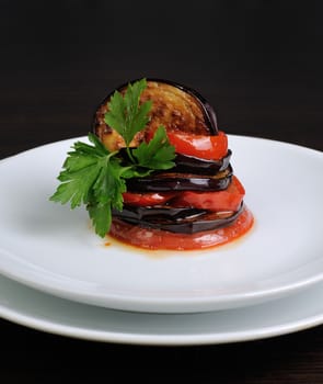 Appetizer of fried eggplant with tomatoes, parsley