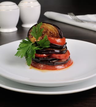 Appetizer of fried eggplant with tomatoes, parsley