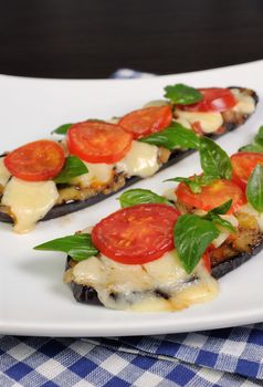 Sliced eggplant baked with tomato and basil and cheese
