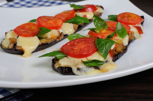 Sliced eggplant baked with tomato and basil and cheese