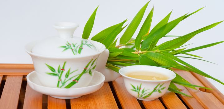 Chinese tea in teapot with cup isolated