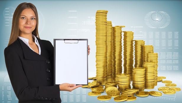 Business woman hold paper holder. Pyramid from gold coins as backdrop