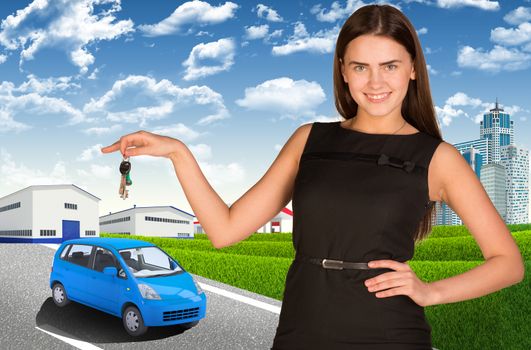 Beautiful young woman with car key in hand. Small automobile on road as backdrop