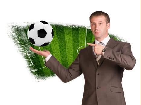 Business man hold soccer ball  in hand. Sport field as backdrop