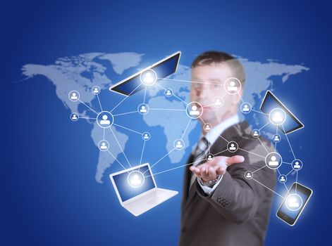 Business man hold tablet pc, smartphone and laptop in hand. World map as backdrop