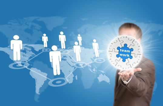 Business man hold puzzle sphere with business label. World map and network as backdrop