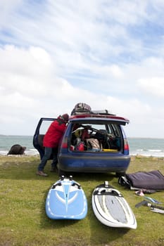 windsurfer getting equipment ready on the beach in the maharees county kerry ireland