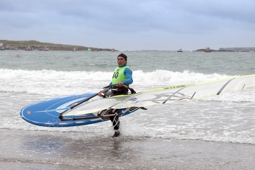 windsurfers getting ready to race and surf on the beach in the maharees county kerry ireland