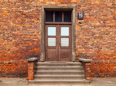 Entrance door with steps to the brick building