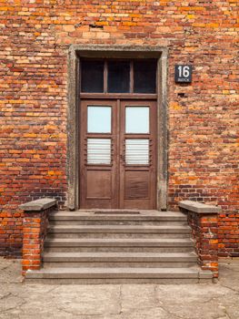 Entrance door with steps to the brick building