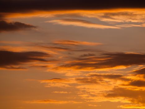 Evening sky with dark clouds brighten by sunset