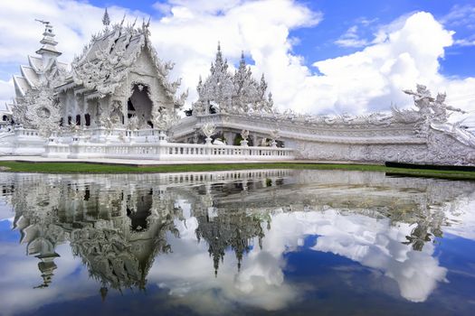 White Temple Reflection. Contemporary unconventional Buddhist temple in Chiang Rai, Thailand.