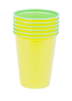 Stack of Yellow and Green Disposable Plastic Cups isolated on white background