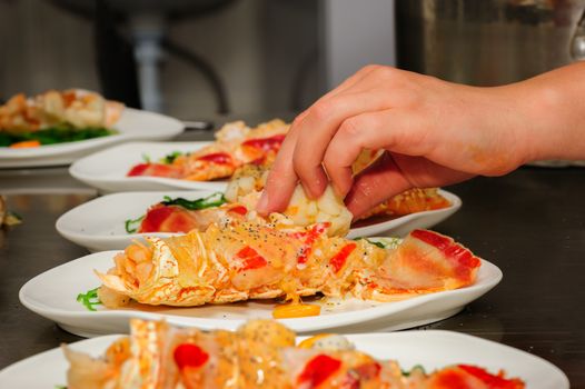 Serving and decorating of prepared lobsters on plates